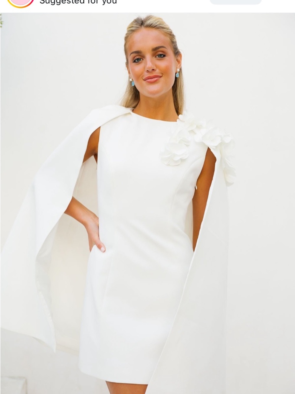 Elegant White Mini Dress with Draped Cape and Floral Shoulder Detail